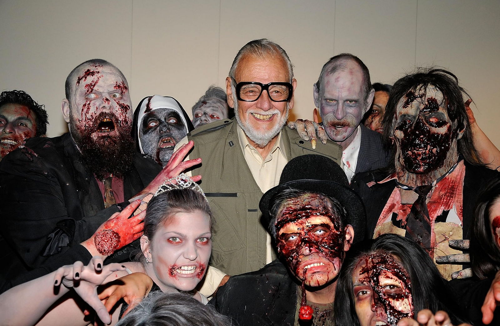 Romero alongside a number of actors dressed up as zombies.