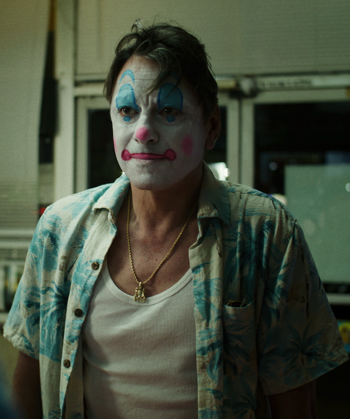 An image of a middle-aged man wearing clown makeup.